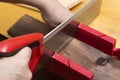 Close up of builders with arm saw sawing board Royalty Free Stock Photo